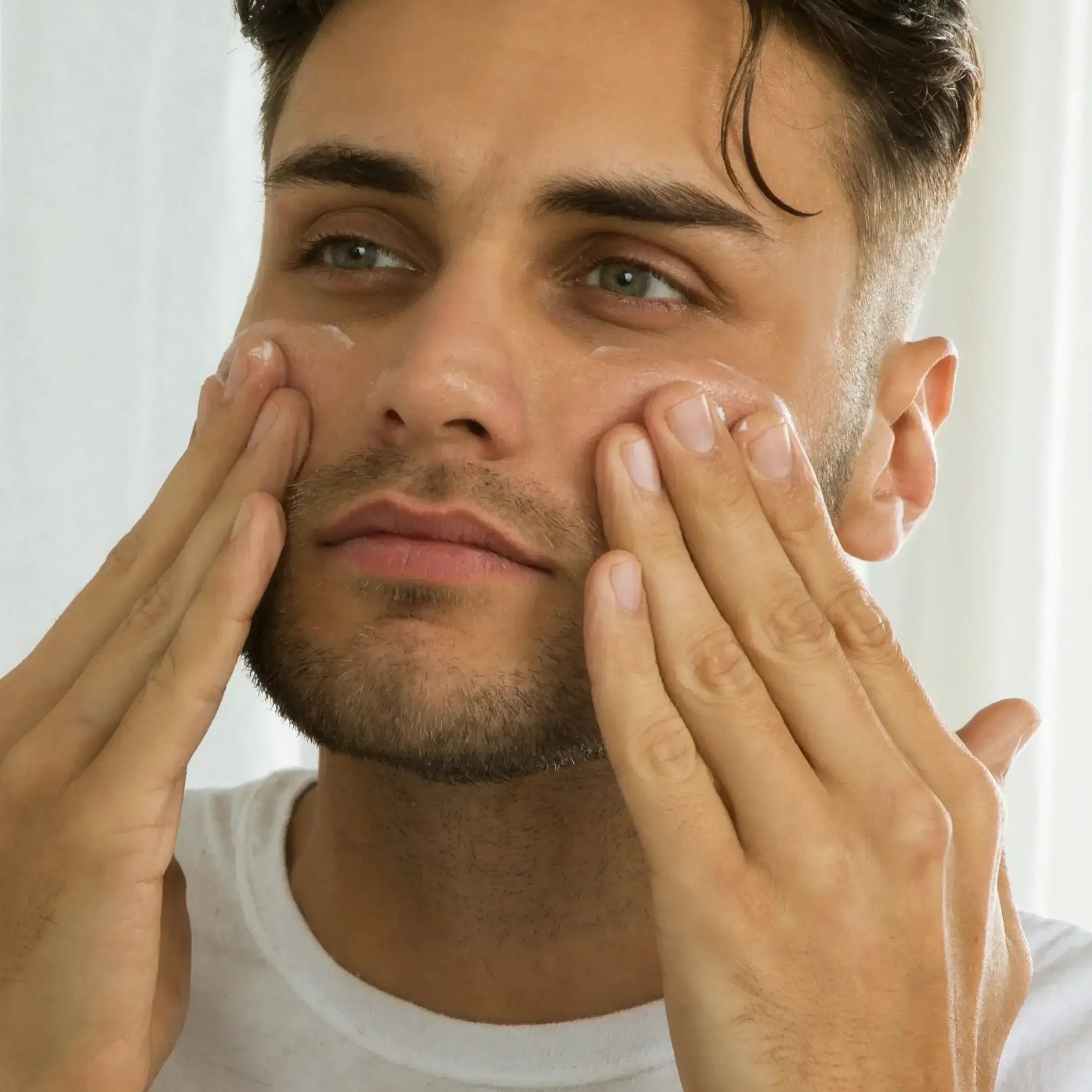 Man applying face moisturizer