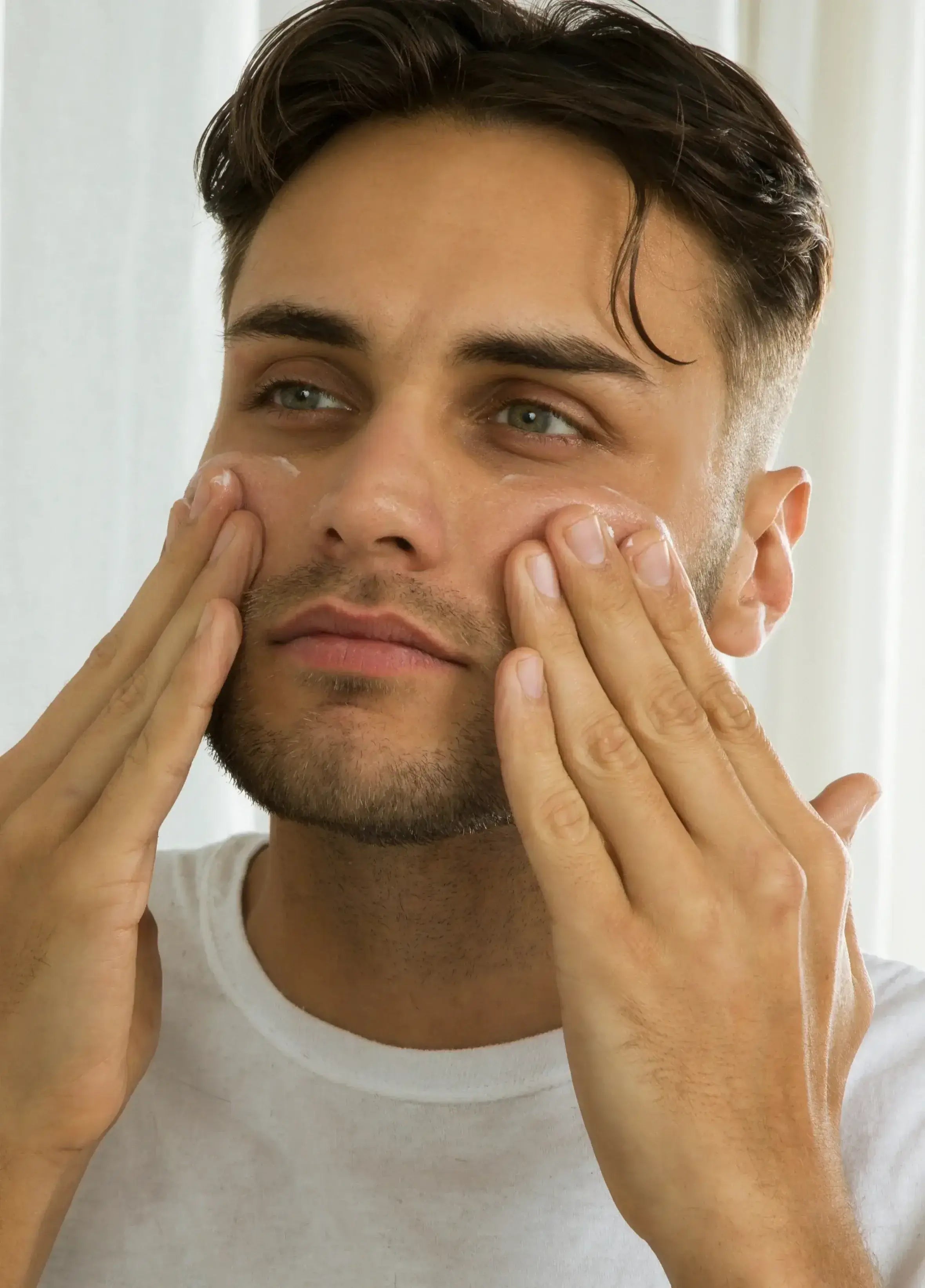 Man applying face moisturizer