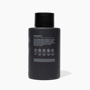 Black bottle with ingredient list on a white background