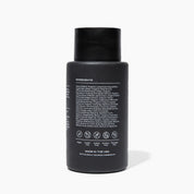 Black bottle with ingredient list on a white background
