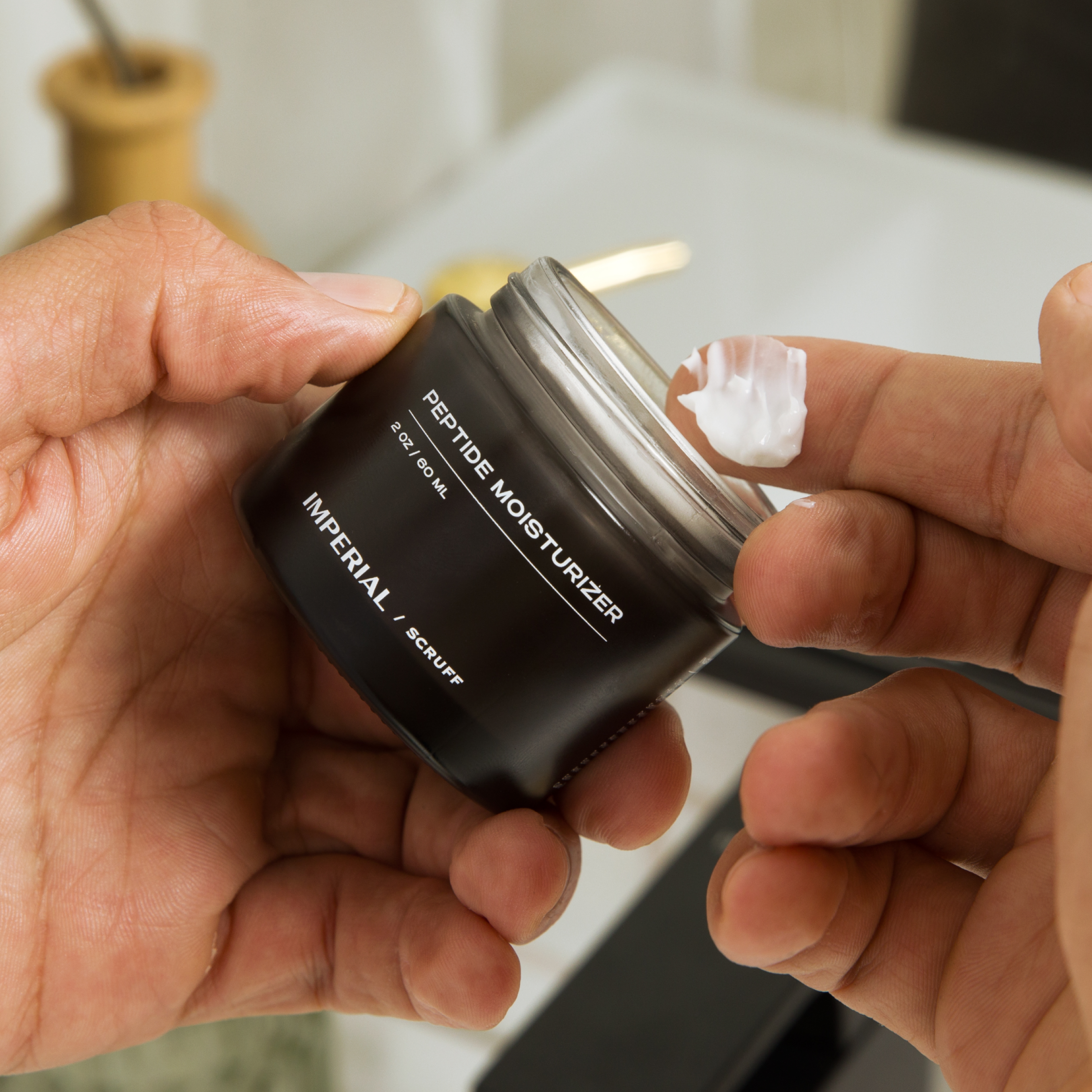 Imperial Scruff Peptide Moisturizer shown on a finger
