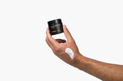 Imperial Scruff Peptide Moisturizer bottle in man's hand with cream on his hand