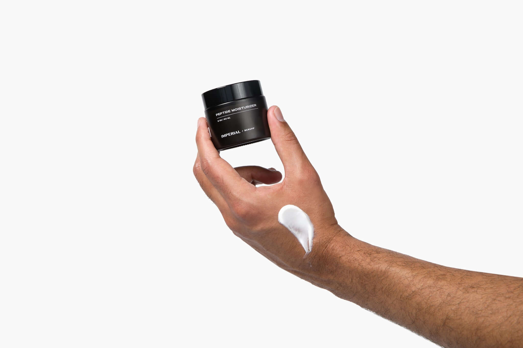 Imperial Scruff Peptide Moisturizer bottle in man's hand with cream on his hand